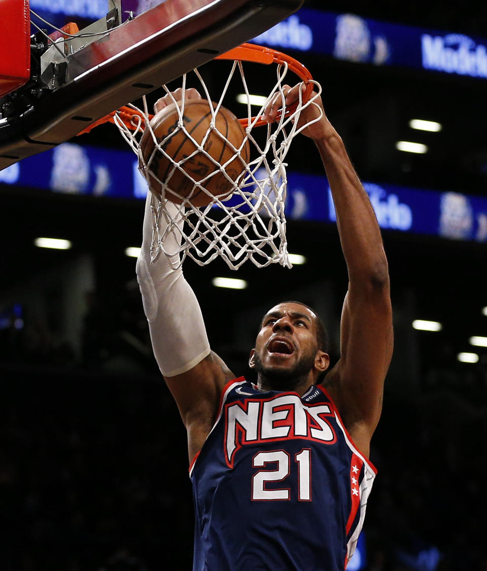 FILE - Brooklyn Nets center LaMarcus Aldridge (21) dunks against the Chicago Bulls during the second half of an NBA basketball game in New York, Saturday, Dec. 4, 2021. LaMarcus Aldridge announced Friday, March 31, 2023, he is retiring again from the NBA. The 37-year-old initially retired in 2021 after experiencing an irregular heartbeat in the last of five games he played for the Brooklyn Nets that season. He rejoined the Nets five months after announcing his retirement.(AP Photo/Noah K. Murray, File)