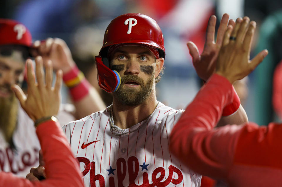 Philadelphia Phillies' Bryce Harper celebrates with teammates after his run during the fourth inning of a baseball game against the Boston Red Sox, Friday, May 5, 2023, in Philadelphia. (AP Photo/Chris Szagola)