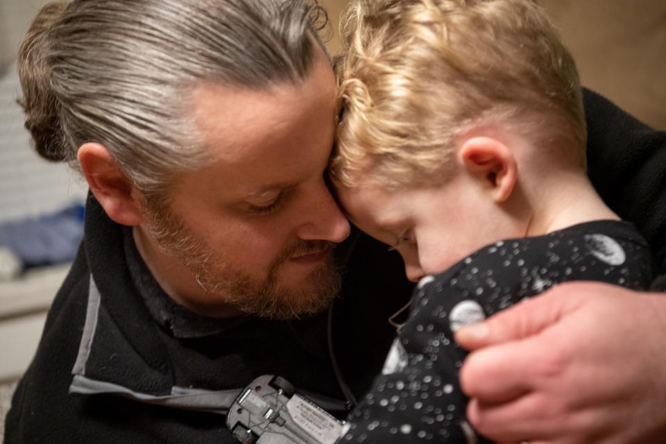 Bill Kinkle shares a moment with his son Isaiah before dinner at his home in Willow Grove, PA.