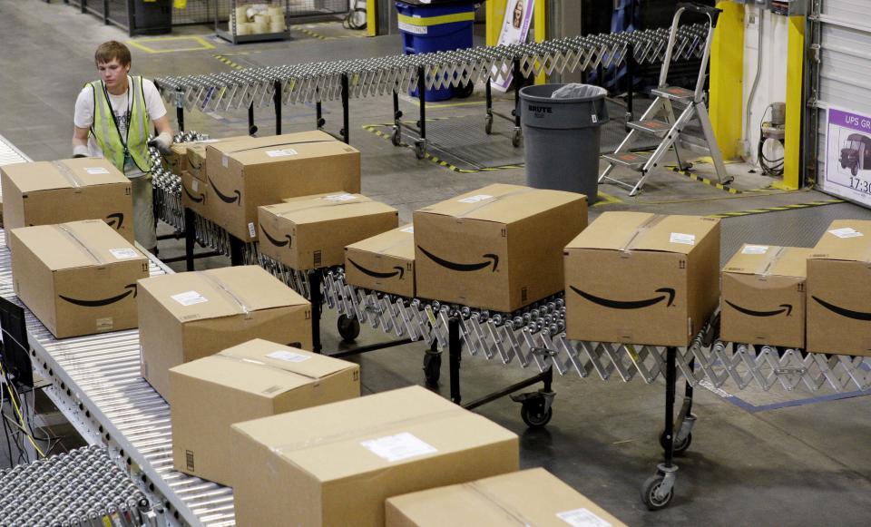 Amazon FILE - In this file photo made Nov. 16, 2009, Stephen Guymon, of Twin Falls, Idaho, separates packages for final shipment inside the 800,000 sq. ft. Amazon.com warehouse in Goodyear, Ariz. Amazon.com Inc., reports quarterly earnings Thursday, April 22, 2010, after the market close. (AP Photo/Ross D. Franklin file)