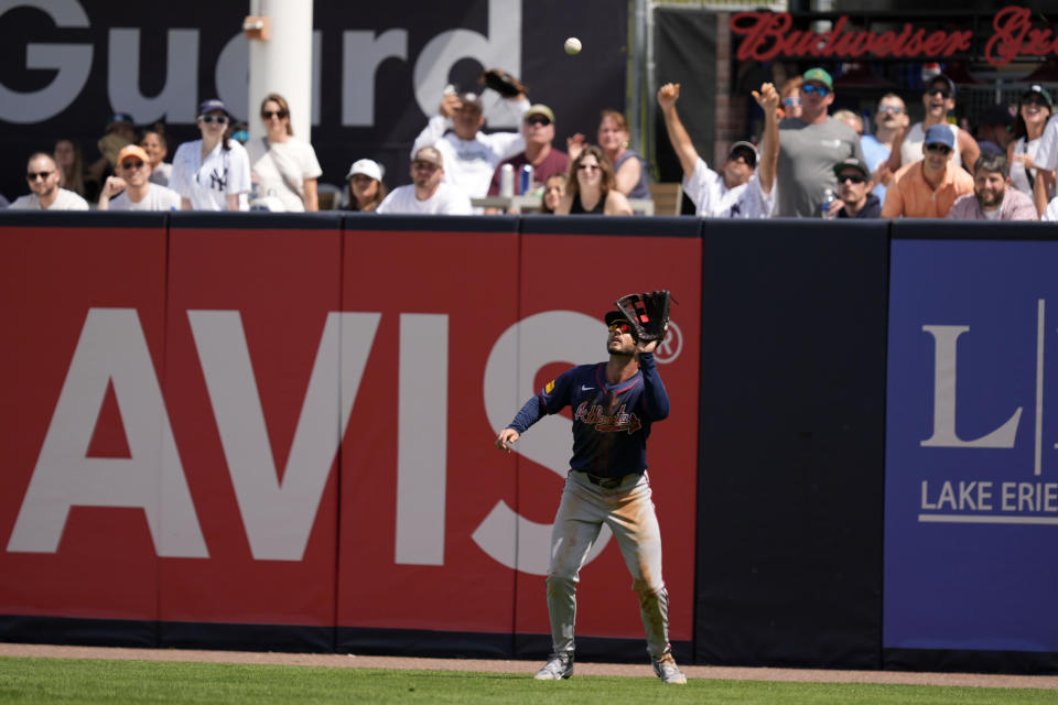 Atlanta Braves right fielder Forrest Wall catches a fly ball hit by New York Yankees' Giancarlo Stanton in the third inning of a spring training baseball game Sunday, March 10, 2024, in Tampa, Fla. (AP Photo/Charlie Neibergall)