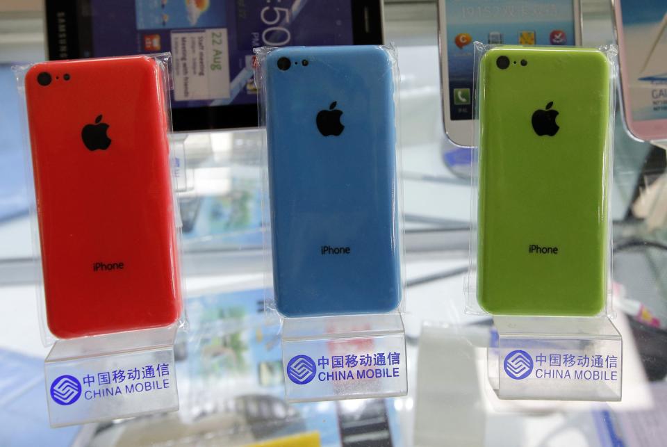 Apple's iPhone 5Cs are displayed on racks bearing the logo of China Mobile in Beijing