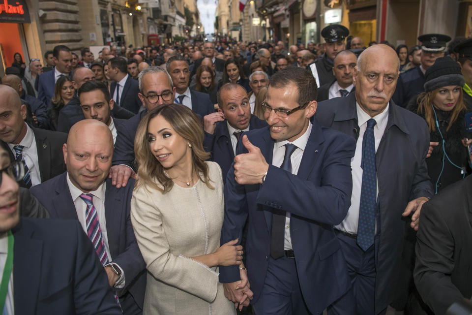 The new Prime Minister of Malta Robert Abela with his wife Lydia Abela, walks out of the Presidential palace in Valletta, Malta, after the swear-in ceremony, Monday, Jan. 13, 2020. Abela is replacing Joseph Muscat after weeks of protests demanding accountability in the investigation of the car bomb slaying of an anti-corruption journalist who targeted his government. (AP Photo/Rene' Rossignaud)