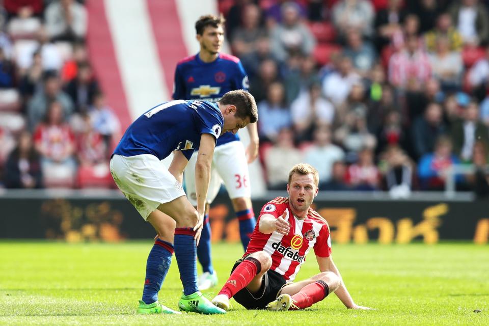 Ander Herrera rubs his leg after the tackle