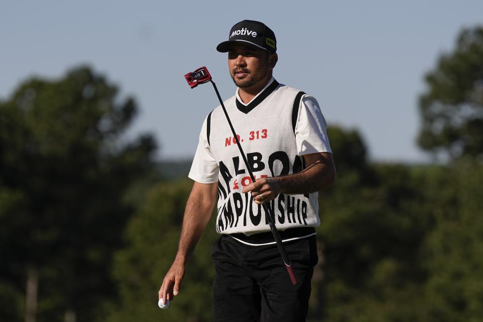 Jason Day, of Australia, waves after making a putt on the 18th hole during the weather delayed first round round at the Masters golf tournament at Augusta National Golf Club Friday, April 12, 2024, in Augusta, Ga. (AP Photo/George Walker IV)