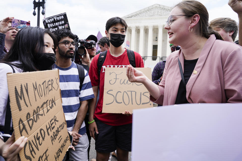 Abortion-rights activists, at left, confront anti-abortion activists, at right, react following Supreme Court's decision to overturn Roe v. Wade in Washington, Friday, June 24, 2022. The Supreme Court has ended constitutional protections for abortion that had been in place nearly 50 years, a decision by its conservative majority to overturn the court's landmark abortion cases.(AP Photo/Jacquelyn Martin)