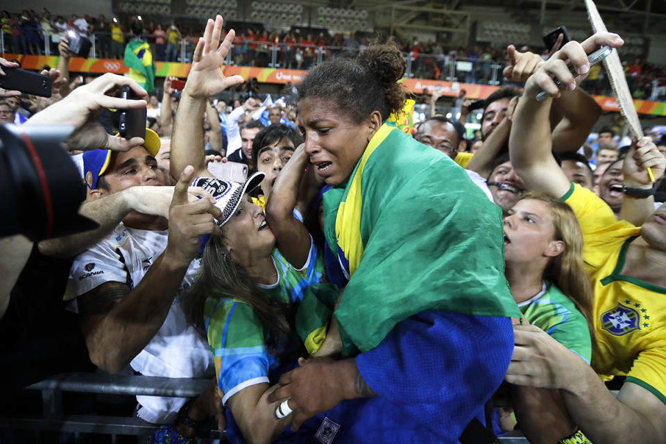 <p>Brazil’s Rafaela Silva, centre, celebrates after winning the gold medal of the women’s 57-kg judo competition at the 2016 Summer Olympics in Rio de Janeiro, Brazil, Monday, Aug. 8, 2016. (AP Photo/Markus Schreiber) </p>