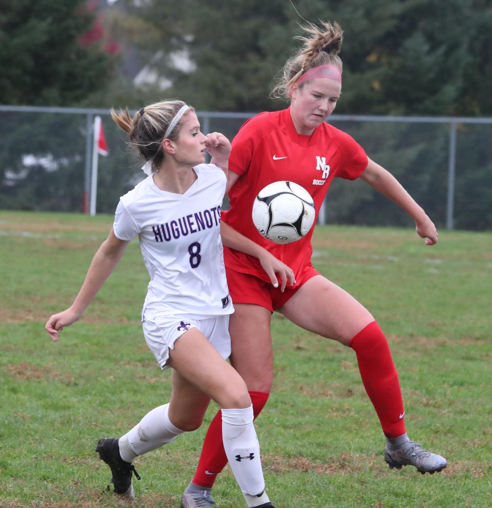 North Rockland's Megan McGovern, right, fights for the ball with New Rochelle's Alexandra Rivera during their Section 1 Class AA quarterfinal at North Rockland Oct. 24, 2022.