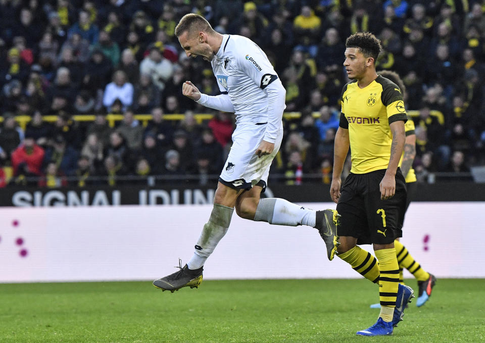 Hoffenheim's scorer Pavel Kaderabek, left, celebrates his goal beside Dortmund's Jadon Sancho, right, during the German Bundesliga soccer match between Borussia Dortmund and TSG 1899 Hoffenheim in Dortmund, Germany, Saturday, Feb. 9, 2019. The match ended 3-3. (AP Photo/Martin Meissner)