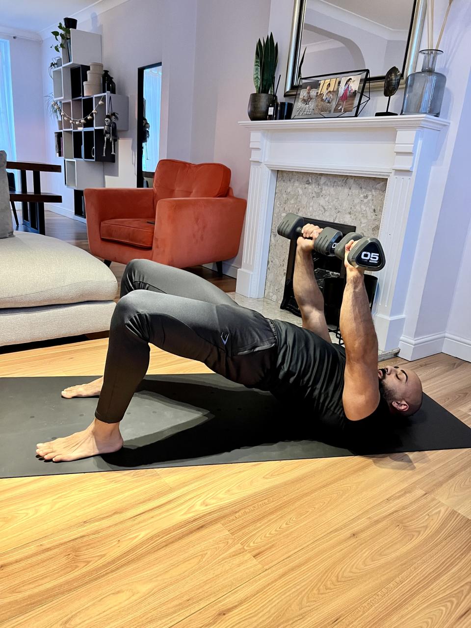 Personal trainer Ali Malik demonstrating the glute bridge chest press