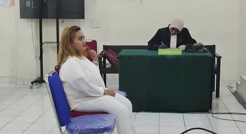 Lina Lutfiawati, who is also known as Lina Mukherjee sits on the defendant's chair during her trial at court in Palembang, South Sumatra, Indonesia, Tuesday, Sept 19, 2023. A court in Indonesia on Tuesday sentenced a woman to two years in prison after citing an Muslim prayer before eating pork that was published on her TikTok video. (AP Photo/Mohammad Fadli)