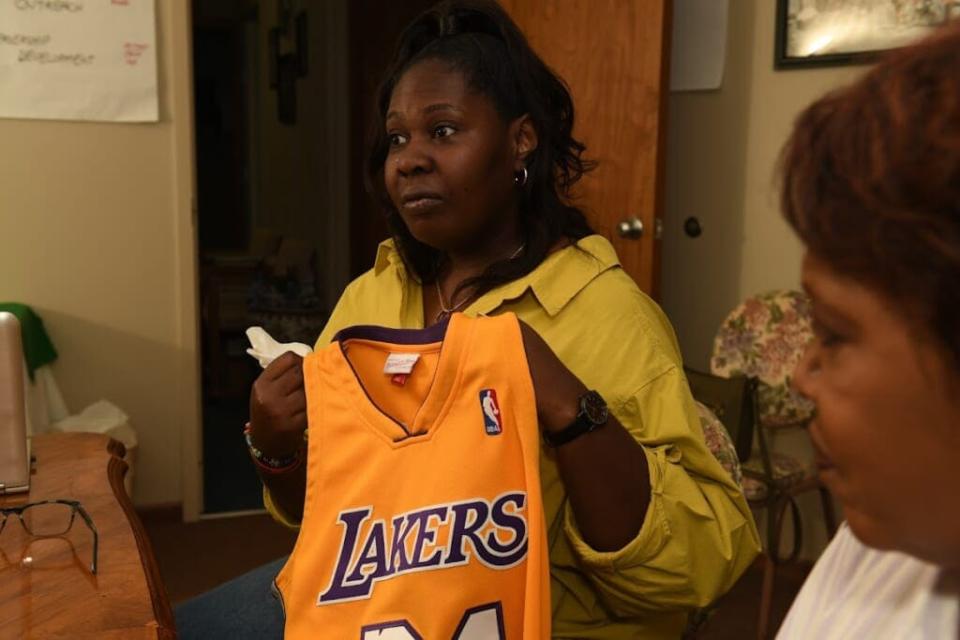 Jada Walker holds the Los Angeles Lakers jersey she purchased for her brother, Jayland, on his 25th birthday (Photo credit: Ken Love Photography)