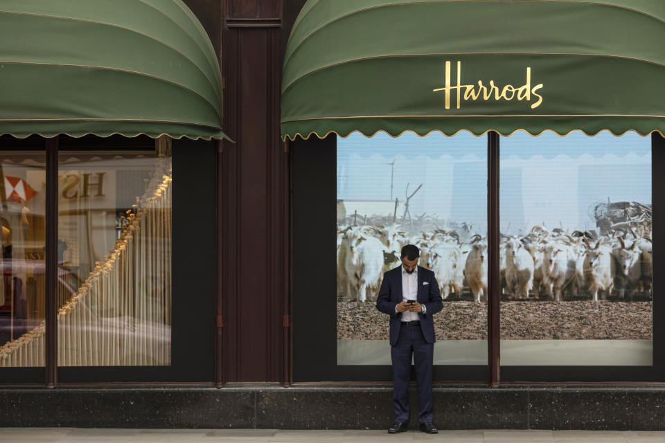 LONDON, ENGLAND - OCTOBER 11: A man checks his phone outside the department store Harrods, near the home of Zamira Hajiyeva, the wife of Azerbaijan state banker Jahangir Hajiyev, on October 11, 2018 in London, England. Zamira Hajiyeva is the subject of the first two unexplained wealth orders obtained by the UK National Crime Agency. Hajiyeva's husband, Azerbaijan state banker Jahangir Hajiyev was jailed in his home country for embezzlement. Under the wealth orders she will need to explain a decade of spending in the Knightsbridge luxury goods store Harrods, where her bill to date is £16million GBP and how she paid for two London properties worth a total of £22million GBP. (Photo by Dan Kitwood/Getty Images)