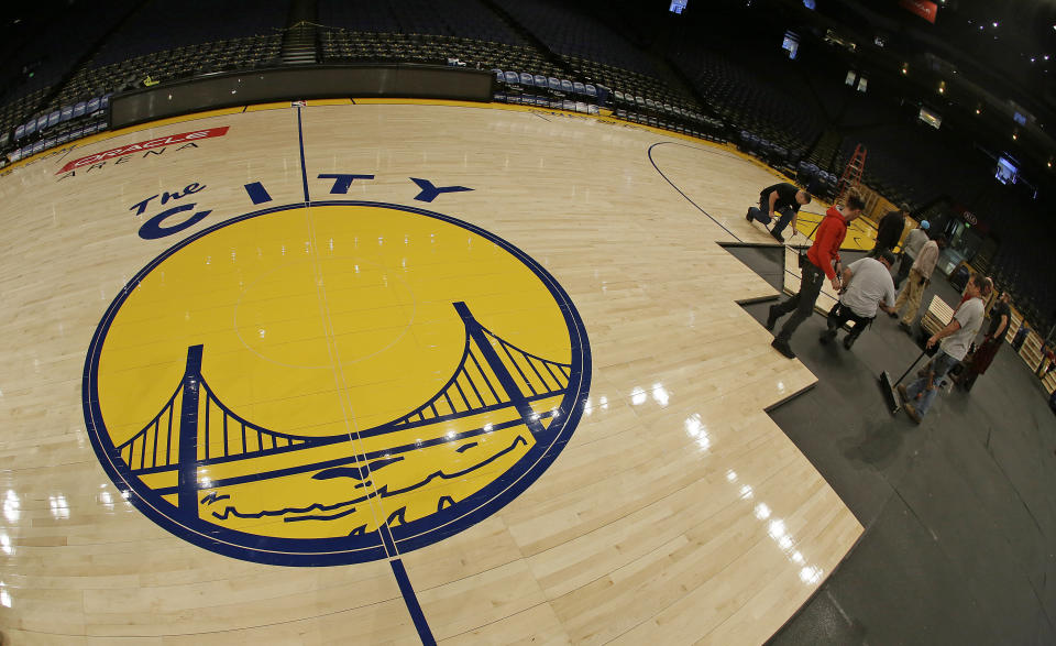 FILE - The City" logo of the Golden State Warriors is displayed after being installed on the floor of Oracle Arena, Nov.16, 2015, in Oakland, Calif. In 2015 StubHub sued Ticketmaster and the Golden State Warriors, alleging it unfairly required fans looking to resell tickets to use Ticketmaster's resale exchange. (AP Photo/Eric Risberg, File)