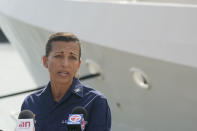 U.S. Coast Guard Captain Jo-Ann Burdian speaks during a news conference, Thursday, Jan. 27, 2022, at Coast Guard Sector Miami in Miami Beach, Fla. The Coast Guard says it has found four more bodies in its search for dozens of migrants lost at sea off Florida, for a total of five bodies. The maritime security agency said Thursday that it also plans to call off its active search for survivors at sunset if it doesn't receive any new information. (AP Photo/Wilfredo Lee)