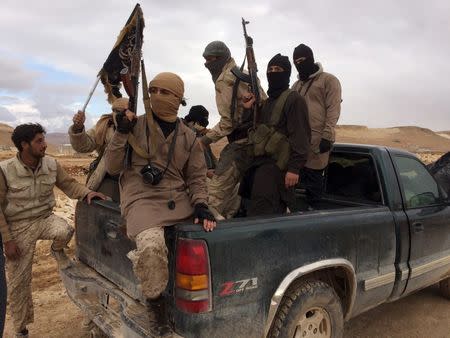 Al Qaeda-linked Nusra Front fighters carry their weapons on the back of a pick-up truck during the release of Lebanese soldiers and policemen in Arsal, eastern Bekaa Valley, Lebanon, in this December 1, 2015 file photo. REUTERS/Stringer