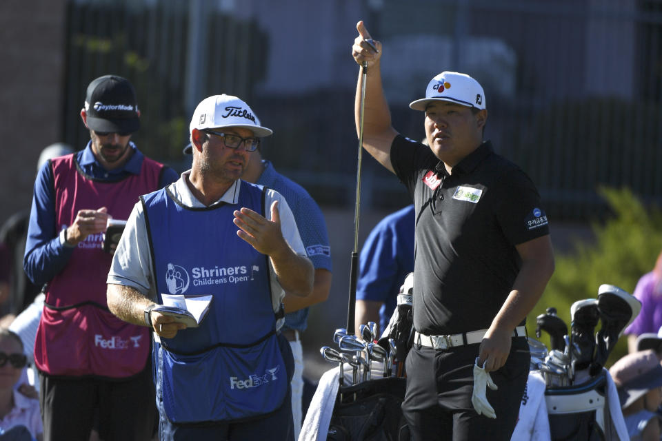 Sungjae Im, right, consults with his caddie about an approach shot during the Shriners Children's Open golf tournament, Sunday, Oct. 10, 2021, at TPC Summerlin in Las Vegas. (AP Photo/Sam Morris)