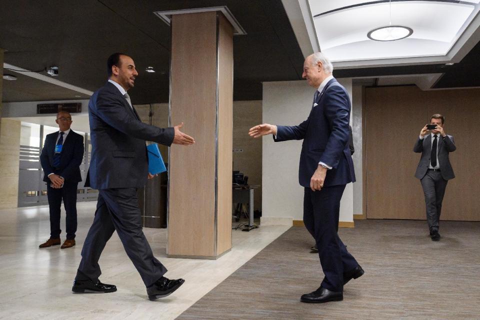 UN Special Envoy for Syria Staffan de Mistura, right, prepares to shake hands with Syria's main opposition High Negotiations Committee, HNC, leader Nasr al-Hariri upon his arrival for a meeting during Syria peace talks in Geneva, Switzerland, Monday,Feb. 27, 2017. (Fabrice Coffrini/Pool Photo via AP)