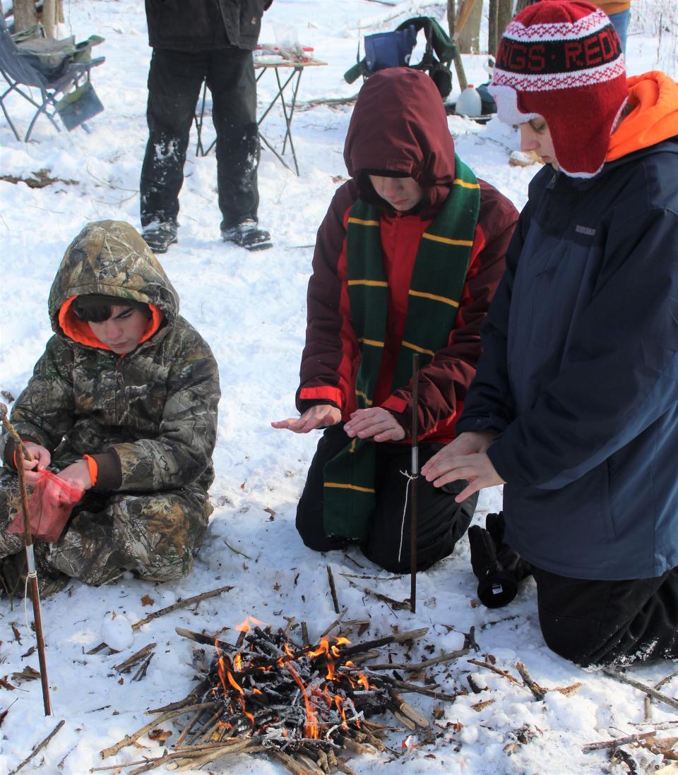 At this fire building station, Scouts from Troop 508 of Carleton keep warm. Provided by Reese Bowling