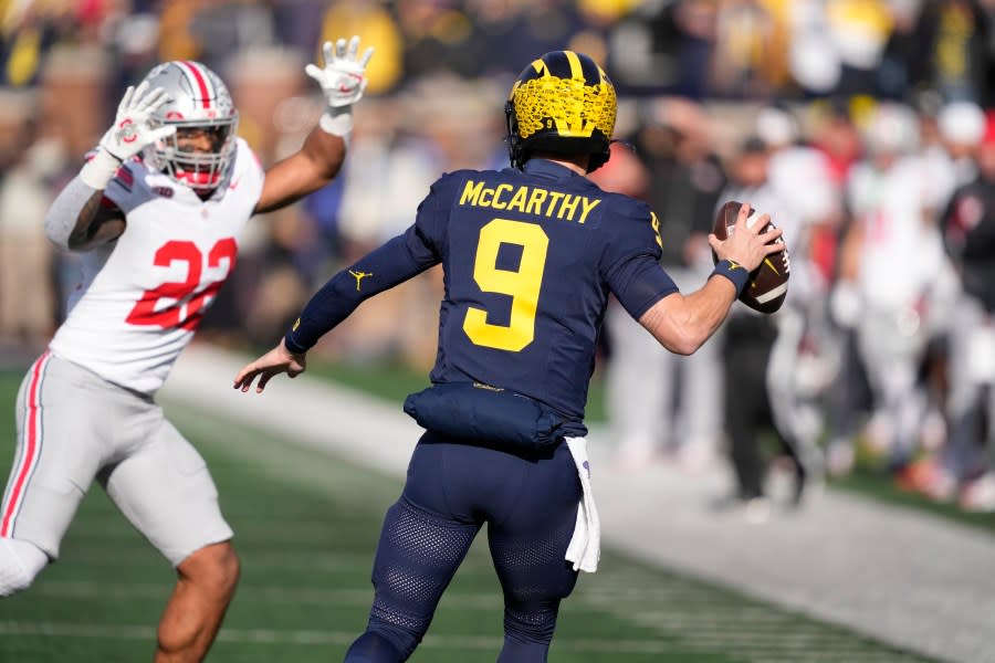 Michigan quarterback J.J. McCarthy (9)kk is pressured by Ohio State linebacker Steele Chambers (22) during the first half of an NCAA college football game, Saturday, Nov. 25, 2023, in Ann Arbor, Mich. (AP Photo/Carlos Osorio)