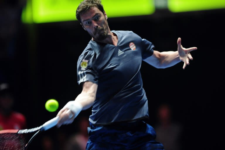 Russia's Marat Safin of Japan Warriors hits a return during the men's singles match at the International Premier Tennis League (IPTL) tournament in Singapore on December 18, 2015