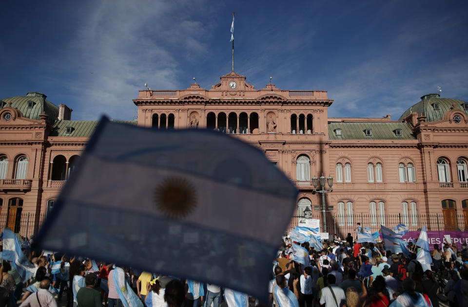 Demonstrators gather in front of Government House to protest against the government of President Alberto Fernandez and its handling of the COVID-19 vaccines, in Buenos Aires, Argentina, Saturday, Feb. 27, 2021. Opposition groups are rallying in response to a recent scandal in which public figures received preferential treatment by receiving COVID-19 vaccines out of turn. (AP Photo/Natacha Pisarenko)