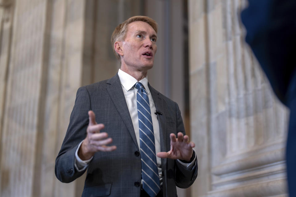 Sen. James Lankford, R-Okla., the lead GOP negotiator on the Senate border and foreign aid package, does a TV news interview on Capitol Hill in Washington, Monday, Feb. 5, 2024. (AP Photo/J. Scott Applewhite)