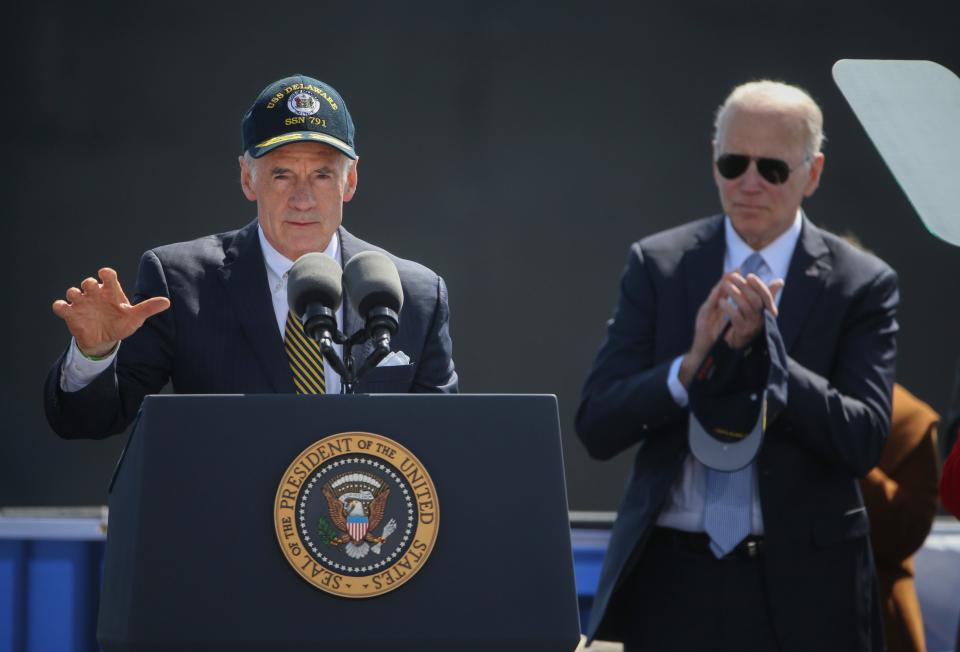 U.S. Sen. Tom Carper delivers the principal address as President Joe Biden looks on during the celebration of commissioning for the USS Delaware attack submarine at the Port of Wilmington on the Delaware River on Saturday, April 2, 2022.