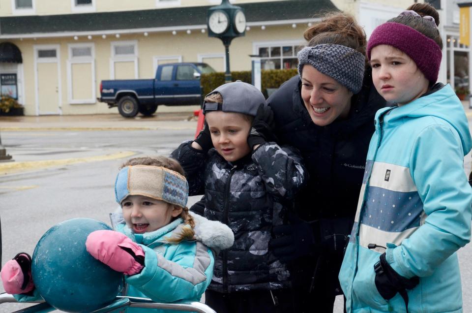 Lindyn MacLean lines up her shot on Saturday, April 1, 2023 as Arlo, Sarah and Joy MacLean watch during the annual Bowling Down Main Street event in downtown Harbor Springs.
