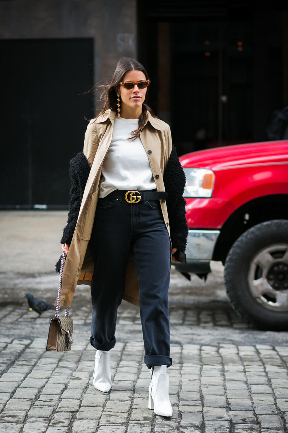 A show-goer heads to Carolina Herrera in a Gucci belt and Adam Selman sunglasses.