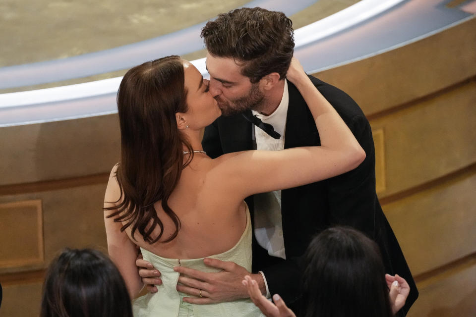 Emma Stone, left, and Dave McCary embrace as Stone wins the award for best performance by an actress in a leading role for "Poor Things" during the Oscars on Sunday, March 10, 2024, at the Dolby Theatre in Los Angeles. (AP Photo/Chris Pizzello)