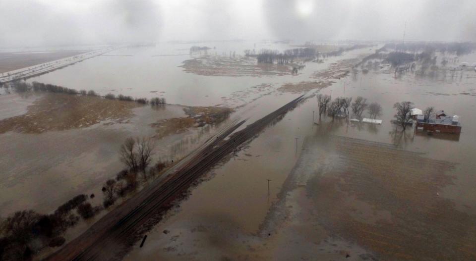 This March 19, 2019 aerial photo shows flooding along the Missouri River in Pacific Junction, Iowa. The U.S. Army Corps of Engineers says rivers breached at least a dozen levees in Nebraska, Iowa and Missouri.