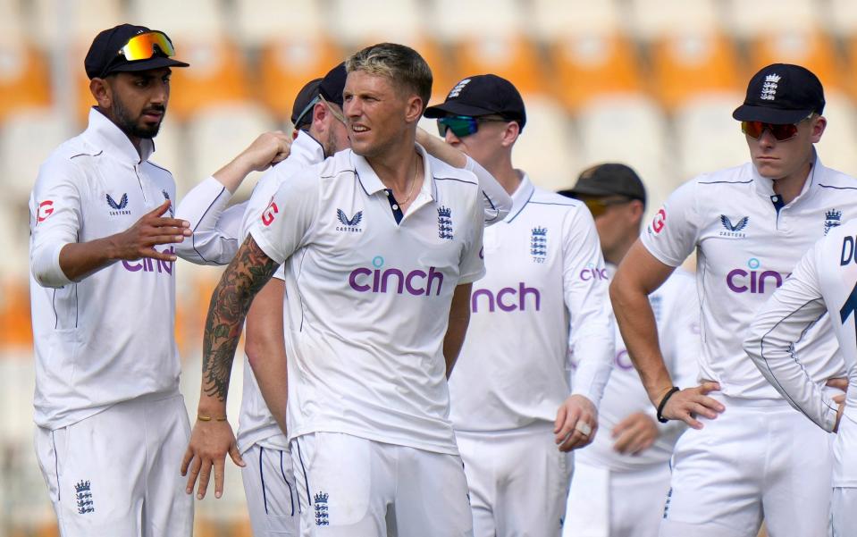 Brydon Carse and his England teammates celebrate a wicket