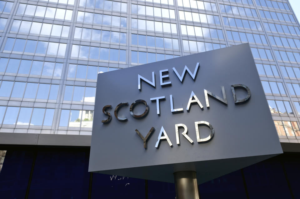 &quot;London, United Kingdom - September 22, 2012: New Scotland Yard, London. Iconic rotating sign outside New Scotland Yard, headquarters of the Metropolitan Police who are responsible for policing Greater London. The sign, which is a tourist attraction, has recently been moved as it was causing congestion at the main entrance to the building.&quot;