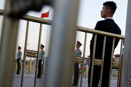 Security officers keep watch at Tiananmen Square in Beijing