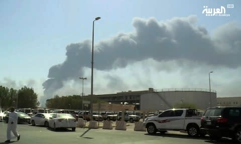 Smoke from a fire at the Abqaiq oil processing facility fills the skyline, in Buqyaq, Saudi Arabia - Credit: Al-Arabiya