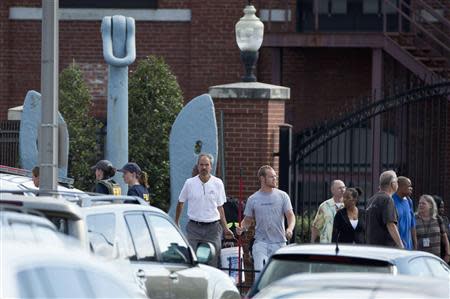 Employees leave after a shooting at the Washington Navy Yard in Washington September 16, 2013. REUTERS/Joshua Roberts