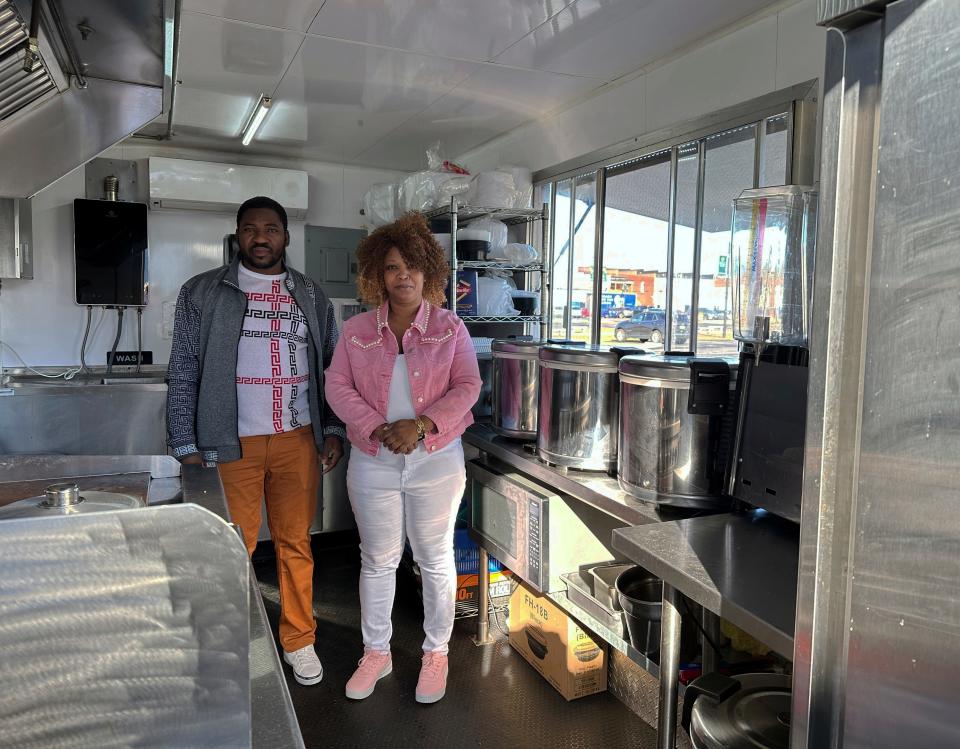 Theslet Benoir and Clemene Bastien stand inside their Eben-Ezer Haitian food truck in Parksley, Va., on Wednesday, Jan. 24, 2024. =