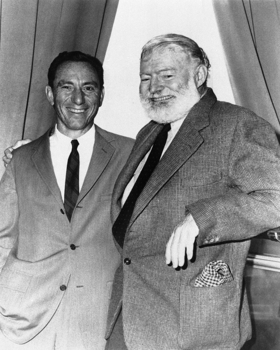 FILE - In this undated file photo, A.E. Hotchner, left, and author Ernest Hemingway pose for a photo in Seattle. Hotchner was staging Hemingway's story "A Short Happy Life" in a pre-Broadway tour in Seattle. A.E. Hotchner, a well-traveled author, playwright and gadabout whose street smarts and famous pals led to a loving, but litigated memoir of Hemingway, business adventures with Paul Newman and a book about his Depression-era childhood that became a Steven Soderbergh film, died Saturday, Feb. 15, 2020, at age 102. (AP Photo, File)