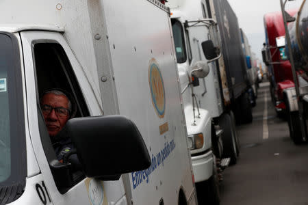 A truck driver waits in a long queue for border customs control to cross into the U.S., at the Otay border crossing in Tijuana, Mexico April 4, 2019. REUTERS/Carlos Jasso