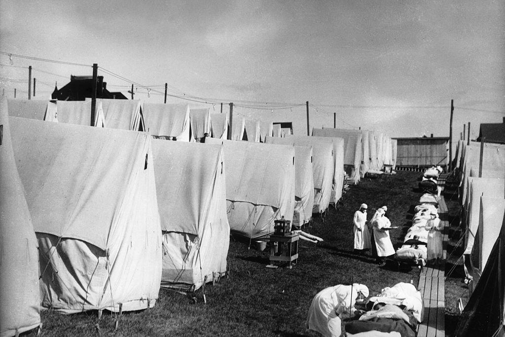 1918: nurses care for victims of a spanish influenza epidemic outdoors amidst canvas tents during an outdoor fresh air cure, lawrence, massachusetts