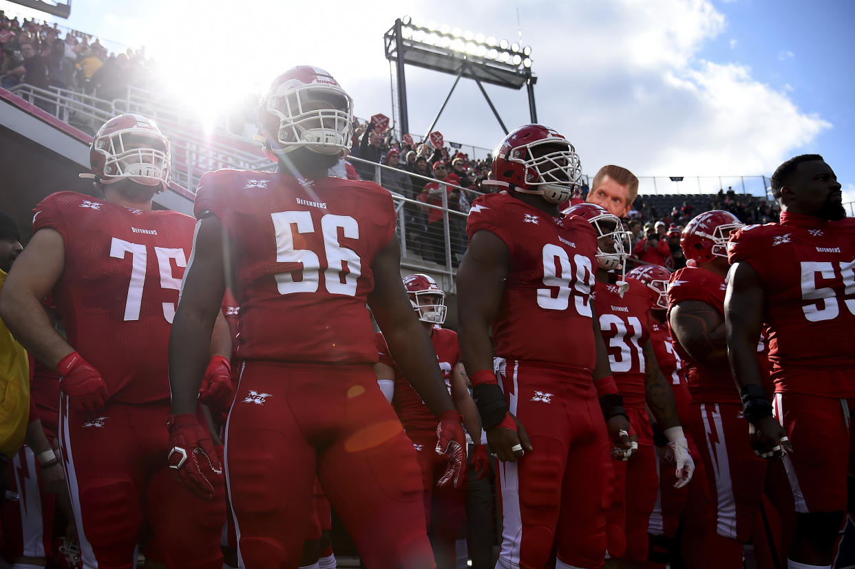 The DC Defenders prepare to take the field prior to an XFL football game against the Seattle Dragons, Saturday, Feb. 8, 2020, in Washington. (AP Photo/Will Newton)