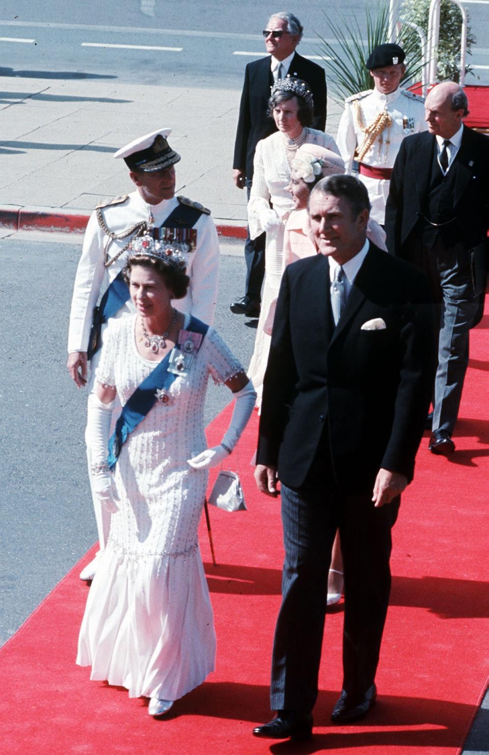 The Queen (followed by the Duke of Edinburgh), is accompanied by then-Australian prime minister Malcolm Fraser during her Silver Jubilee visit to Australia (Ron Bell/PA) (PA Archive)