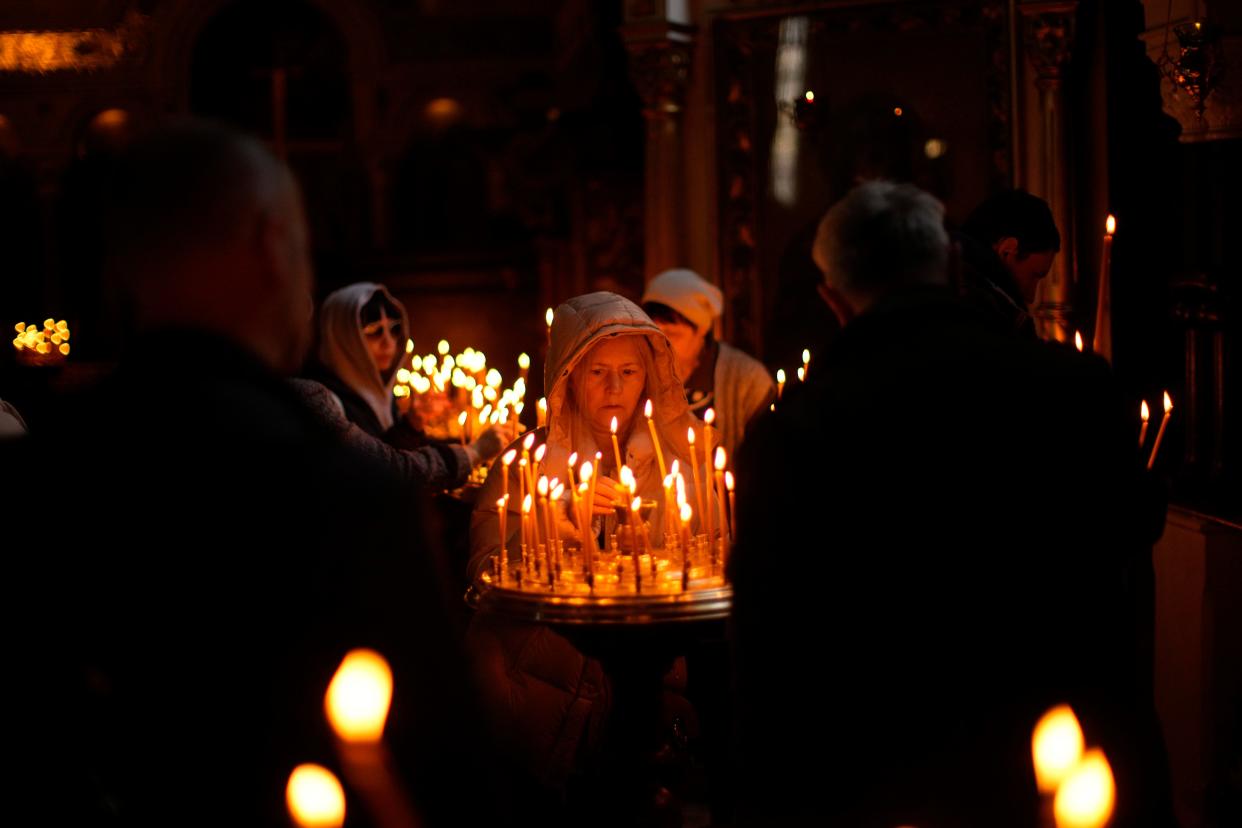Worshippers light candles at the Saint Volodymyr's Cathedral during Orthodox Eastern celebrations in Kyiv, Ukraine, on April 24, 2022.