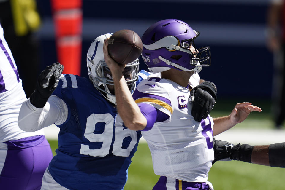 Minnesota Vikings quarterback Kirk Cousins, right, is pressured by dIndianapolis Colts' Denico Autry (96) during the first half of an NFL football game, Sunday, Sept. 20, 2020, in Indianapolis. (AP Photo/Michael Conroy)