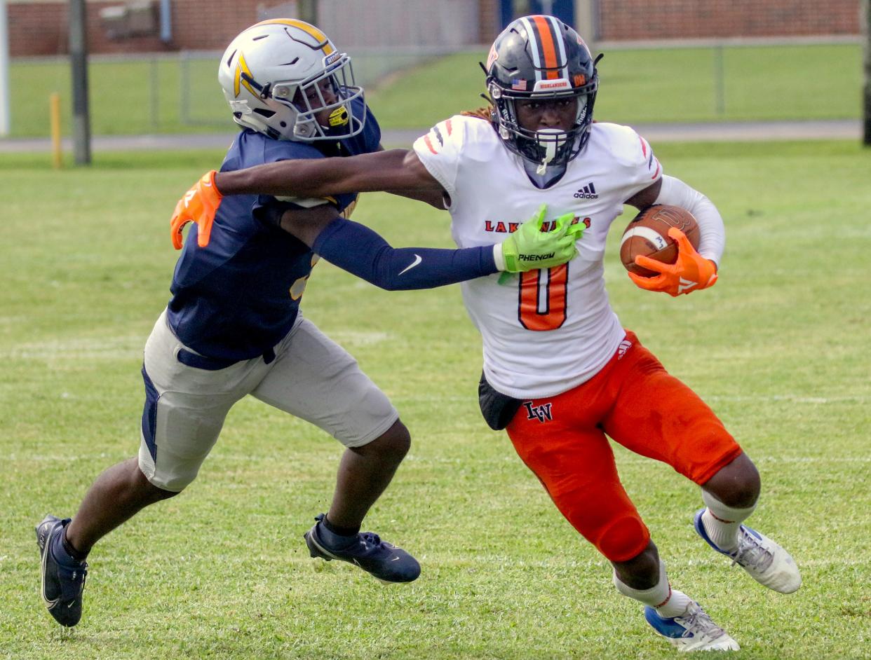 Lake Wales receiver Jaremiah Anglin Jr. tries to escape the grasp of Ridge Community's Andre Berry.