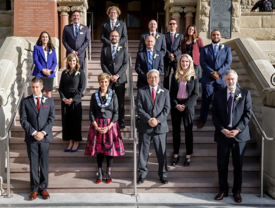 Jyoti Gondek, front row second from left, poses with her council after being sworn-in as the new mayor of Calgary in Calgary, Alta., Monday, Oct. 25, 2021.
