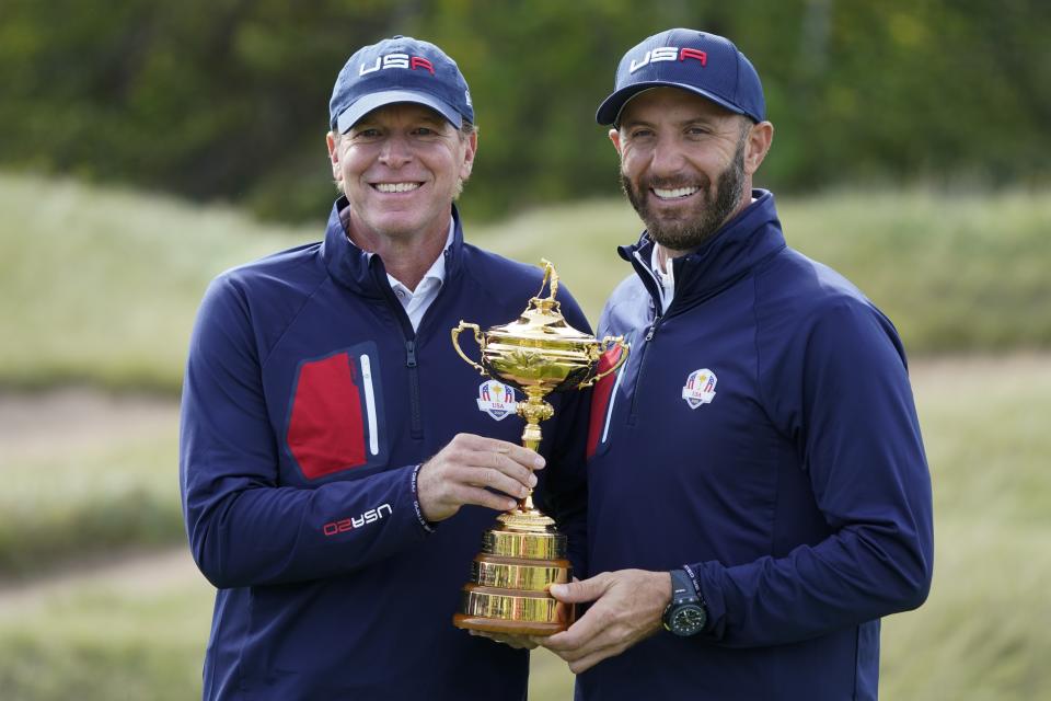 Team USA captain Steve Stricker and Team USA's Dustin Johnson hold the Ryder Cup during a practice day at the Ryder Cup at the Whistling Straits Golf Course Wednesday, Sept. 22, 2021, in Sheboygan, Wis. (AP Photo/Charlie Neibergall)