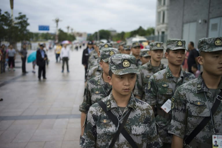 Chinese military guards stand in Tiananmen Square in Beijing prior to a military parade to be held on September 3 to mark the victory over Japan and the end of World War II, on September 1, 2015