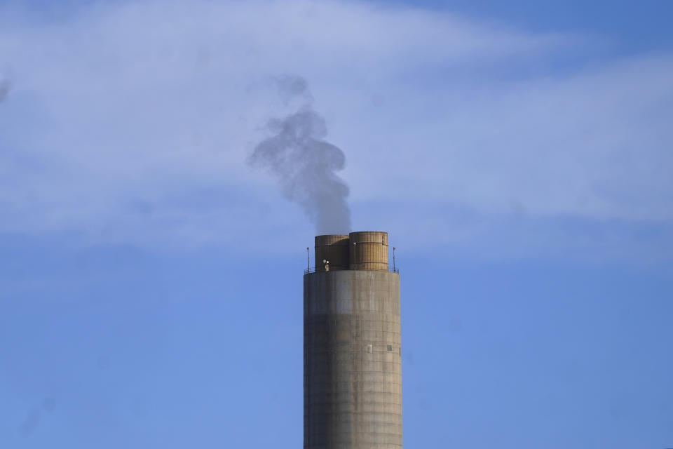 A smokestack stands at a coal plant on Wednesday, June 22, 2022, in Delta, Utah. Developers in rural Utah who want to create big underground caverns to store hydrogen fuel won a $504 million loan guarantee this spring. They plan to convert the site of the plant completely to cleanly-made hydrogen by 2045. (AP Photo/Rick Bowmer)